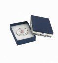 Custom oval pin inside its open gift box on a white background